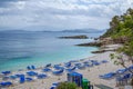 View of empty beach Ã¢â¬â blue deck chairs near sea water, cliffs and rocks Royalty Free Stock Photo